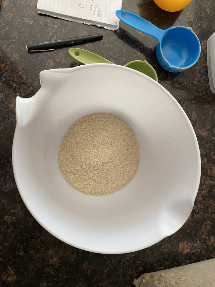 brown rice flour in a white plastic bowl